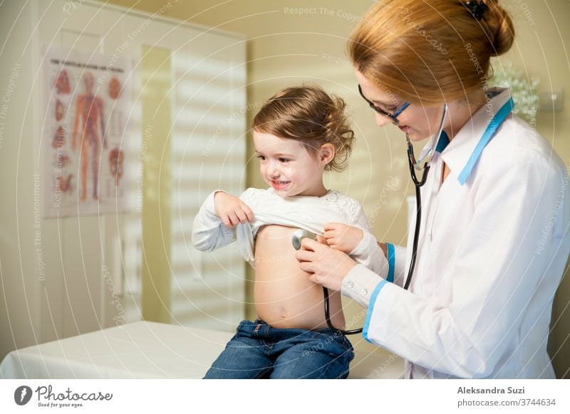 Cute little girl and doctor. Pediatrician woman examining cute little girl with stethoscope. Kid looks healthy and happy pediatrician baby toddler examination