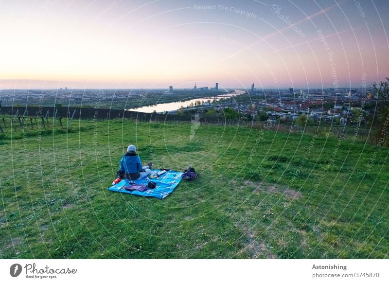 Picnic in the morning with view of Vienna Morning Vantage point Twilight Dawn Woman Blanket Eating Breakfast Nature Landscape Sunrise Colour photo Exterior shot