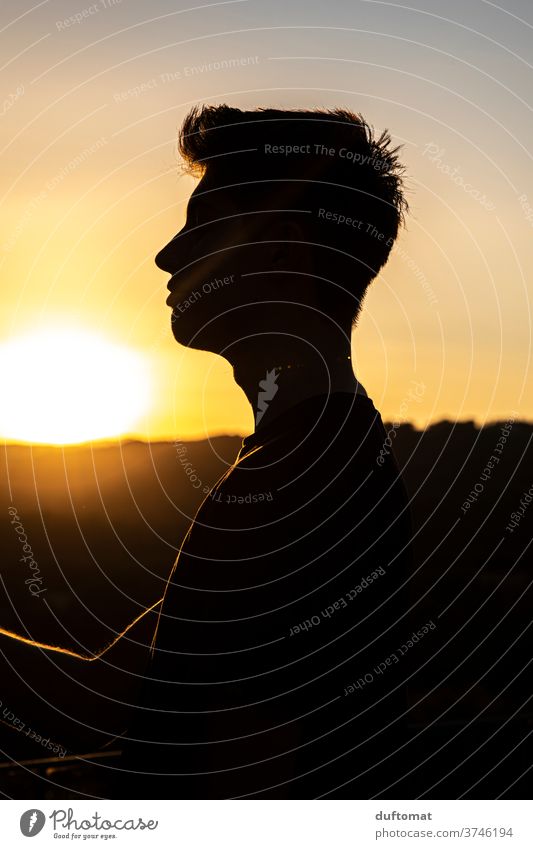 Teenagers in the backlight at sunset Italy Sunset teenager Young man Man Manly Silhouette far vision Vantage point portrait To enjoy sunshine Human being Head