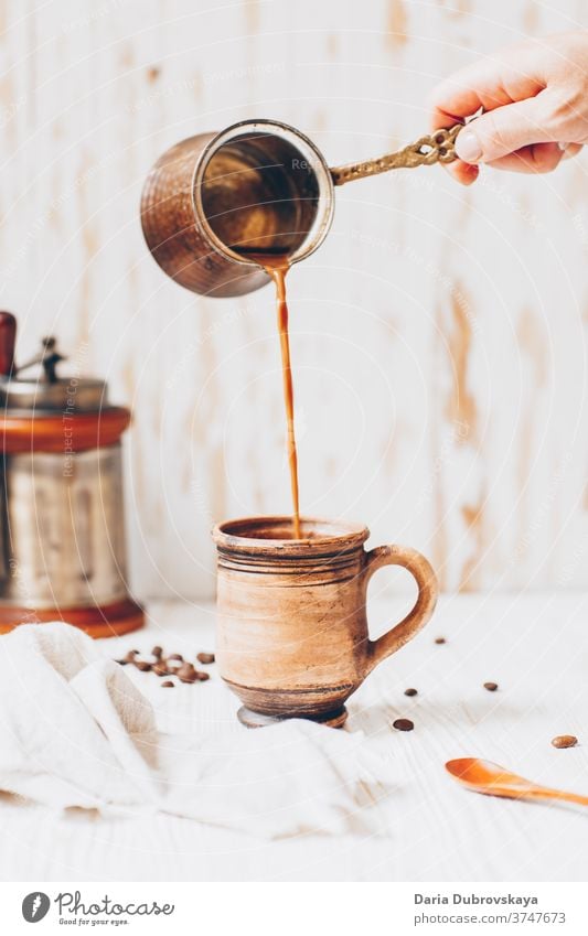 pouring coffee to cup, beans on a wooden background aroma breakfast cafe morning drink brown black dark beverage caffeine hot fresh roasted food natural arabica