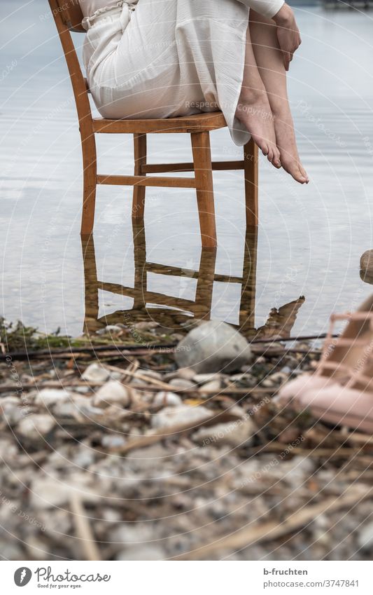 Woman sitting on wooden chair in water Water Chair Wooden chair Armchair Seating Furniture Old Sit Loneliness Brown Relaxation Calm Wait Exterior shot Lakeside