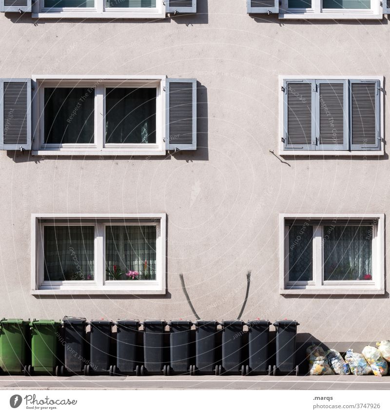 Garbage cans in front of apartment building Apartment house Facade Window Garbage bag Trash Trash container Waste management Refuse disposal Arrangement