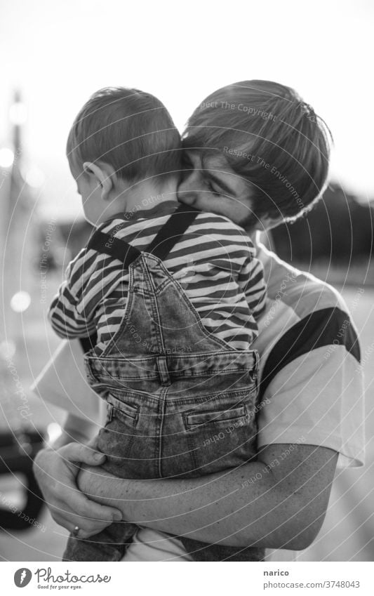 Father holds son lovingly in his arms Toddler Boy (child) Child Exterior shot Infancy 1 - 3 years Nature Overalls Life Human being Shallow depth of field Son