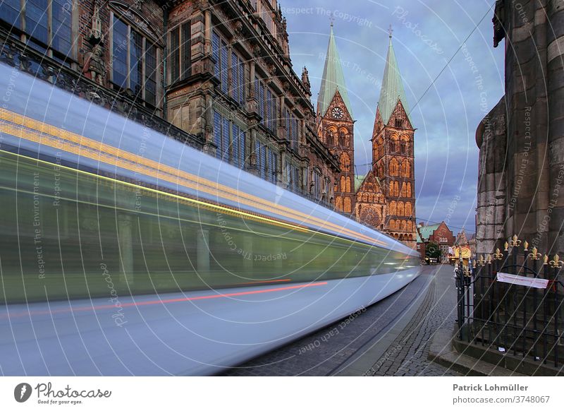 Tram in Bremen City hall Church Church towers Town Street Light Architecture Manmade structures urban Europe Old Dusk St. Petri cathedrale swift Speed tempo
