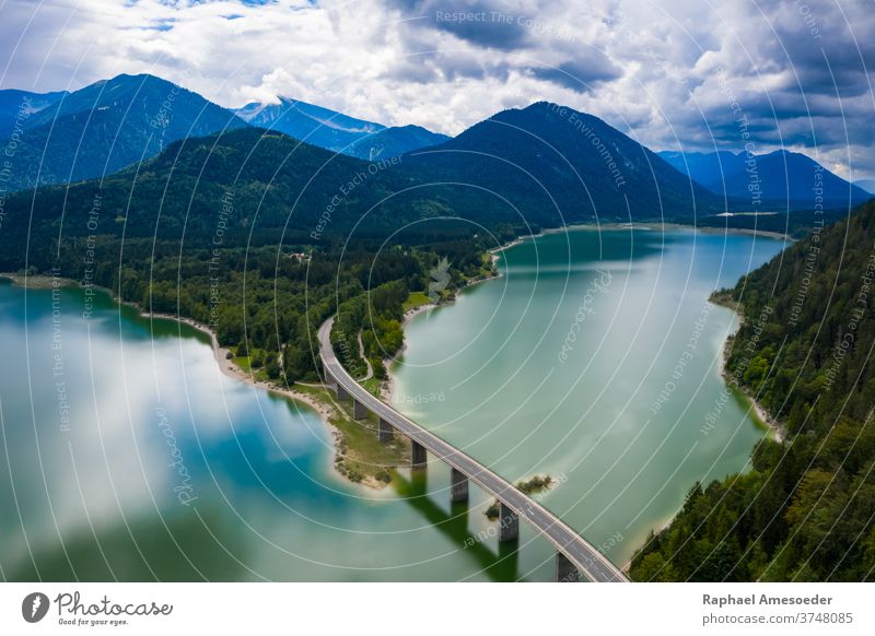 Aerial view of Sylvenstein Lakes on cloudy summer day bridge landscape mountain alps road river isar sylvenstein turquoise aerial bank beach beautiful blue