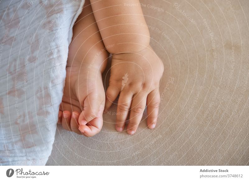 Detail of anonymous baby's hands innocence innocent trust nails affection dreaming infant harmony newborn fingers toddler sleeping support comfortable identity