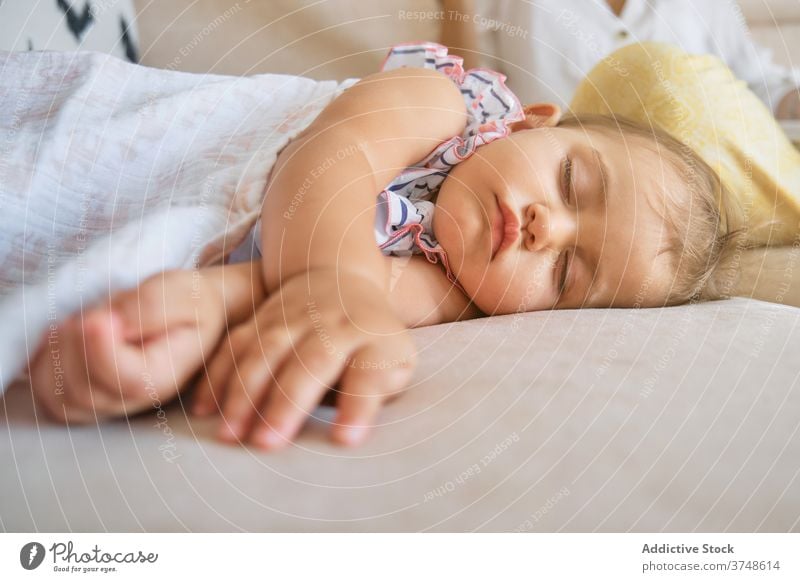 Little girl lying asleep on the couch of a house tenderness tranquility dreaming newborn innocence fingers peace toddler peaceful pillow comfortable deep rest