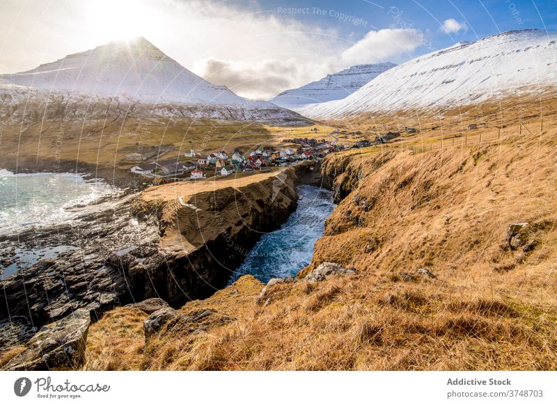 Small settlement in mountains on Faroe Islands village winter snow river season cold house residential faroe islands scenery breathtaking scenic countryside