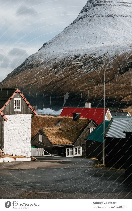 Wooden cottage on Faroe Islands on mountain village houses winter cold mountains nordic faroe islands travel coastal vacation famous place tourism