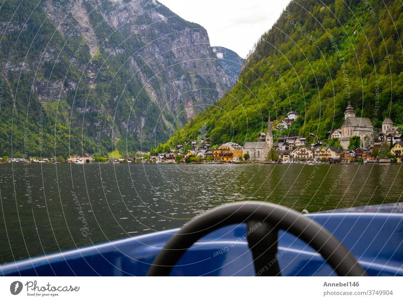 beautiful View of the Hallstatt from lake Hallstater See, Austria with blue boat on the front popular tourist location austria town old heritage europe