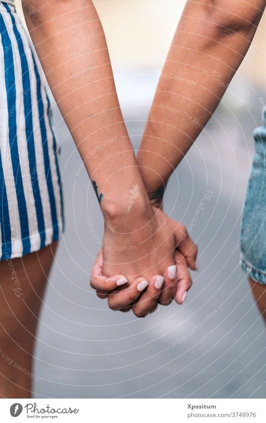 Holding Hands Closeup hands together nails girls sisters faceless love closeup detail holding hands anonymous unrecognized front view portrait two people