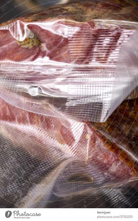 Pastrami packed in plastic bags pastrami dressed Plastic bag sous vide Packaged Tire Vacuum sealed Packaging vacuum-packed Bag Meat Close-up Red Eating