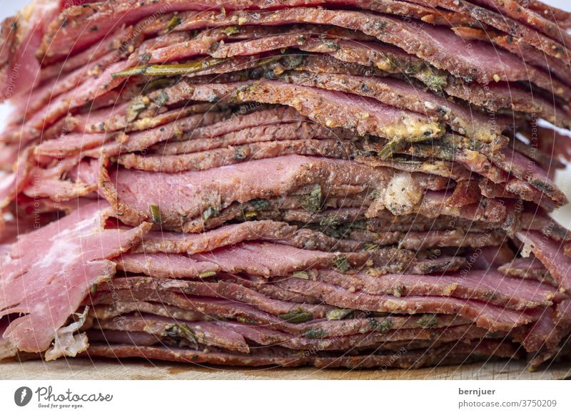 Stack of sliced pastrami meat Beef brisket Rustic slices Slice stacked Meat Close-up Red deli cut chill Folded Thin roasted Eating seethed Delicacies Frying