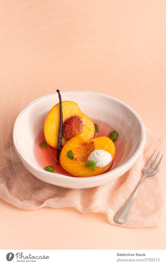 Poached Peaches in white wine, vanilla and basil. orange nectarine decoration sweet plate sauce table dish homemade warm flavour food healthy organic fruit