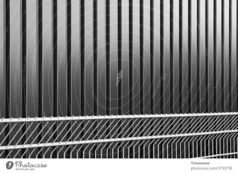 Cool facade and fence Facade Cladding Metal lines Light Shadow Fence Exterior shot built Architecture cordon Black & white photo sober factual