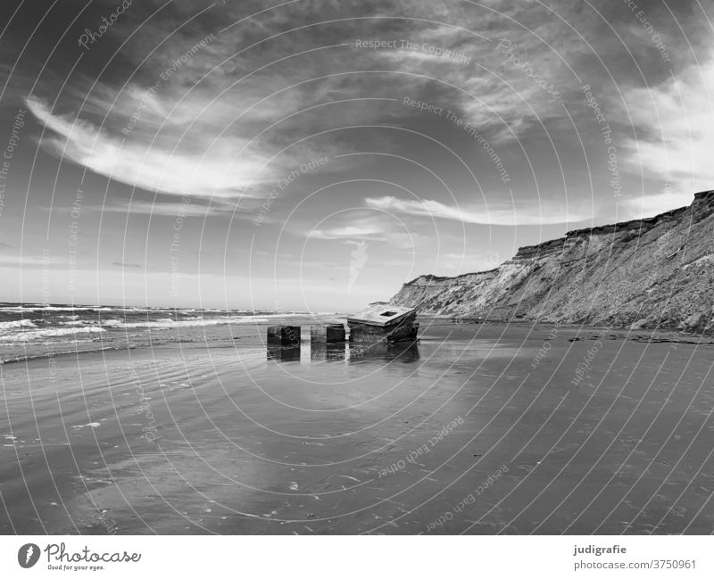 Bunker remains at the beach of Løkken in Denmark Coast Beach Dugout Sky Black & white photo Exterior shot Deserted North Sea Ocean Past History of the Tracks