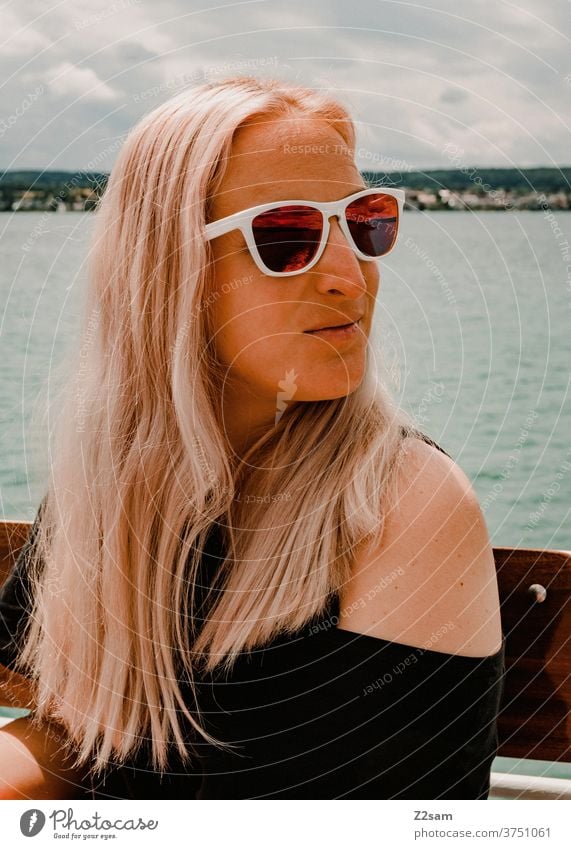 Young woman on the Bodensee Lake Constance Water Body of water Brown Relaxation relaxation Dress Black sunglasses long hairs Sky Blonde Exterior shot Summer