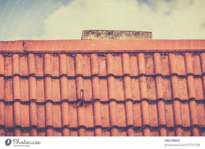 a bit of chimney sticks out from the tiled roof Roof brick roof area cloud Roofer Roofing company Orange Roofing tile series linear Old Red Chimney towering