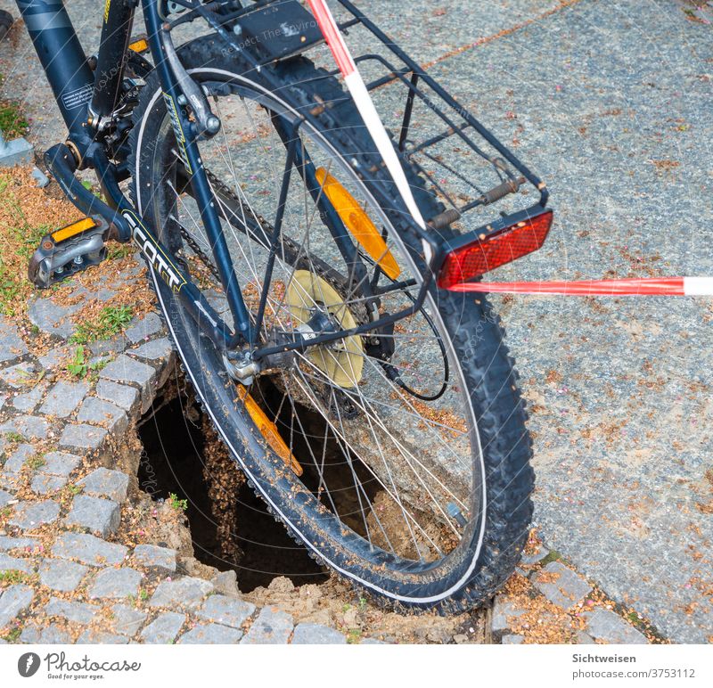 Bicycle over asphalt hole Street Town Road traffic Traffic infrastructure