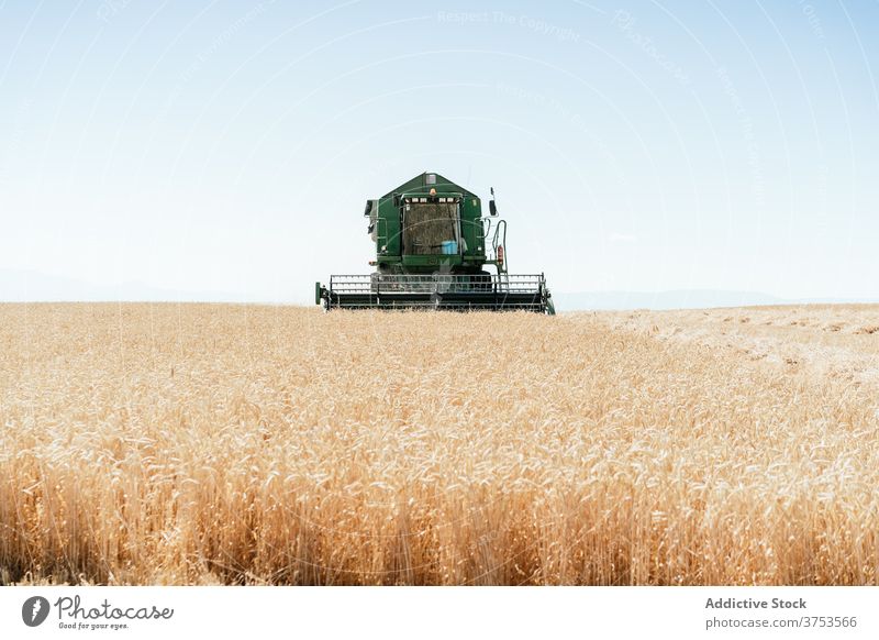 Agricultural machine in filed in summer harvest combine collect field wheat countryside machinery farm agriculture season rural nature meadow farmland