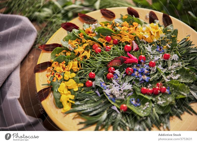Delicious greenery with flower petals on plate composition herb arrangement wooden table ripe fresh nature summer bloom flora healthy season floral plant