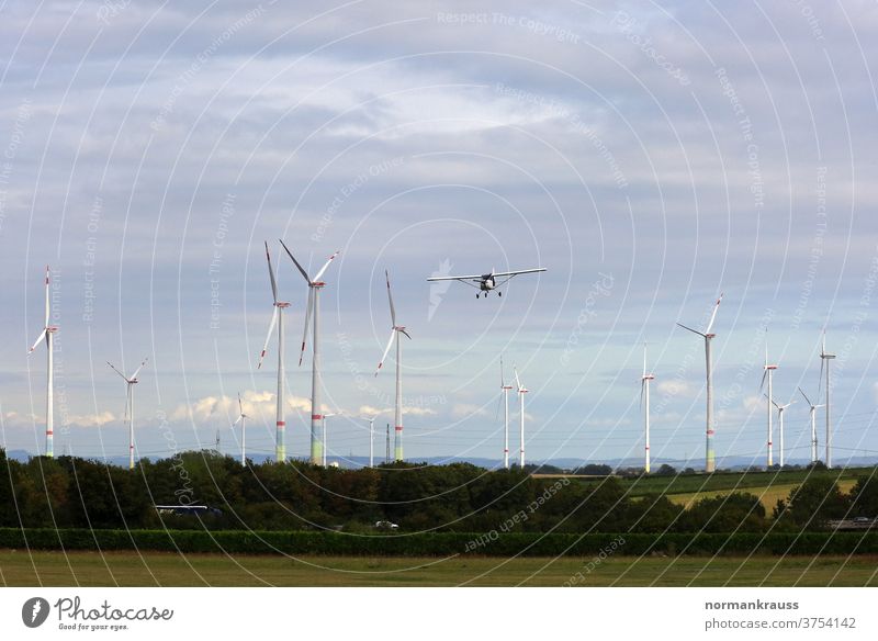 Small aircraft and wind turbines Light aircraft wind farm windmills Airplane Flying approach landing approach wind power Power Generation eco-power ecology