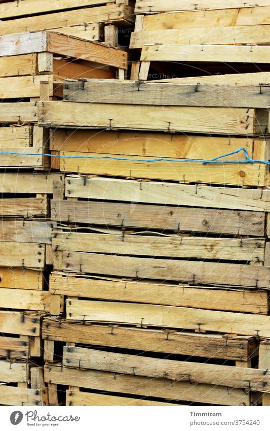 A stack of empty wooden crates Stack Wood crates Wooden box Crate Food Deserted String Wrapped around Tall Colour photo