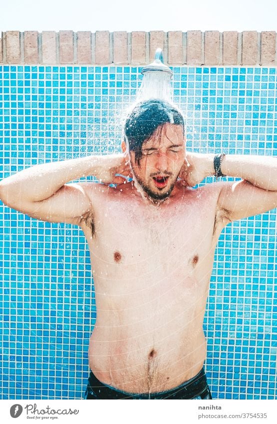 Young man having a shower before pool summer attractive white caucasian tan real real people real man candid fresh freshness cool coolness body real body