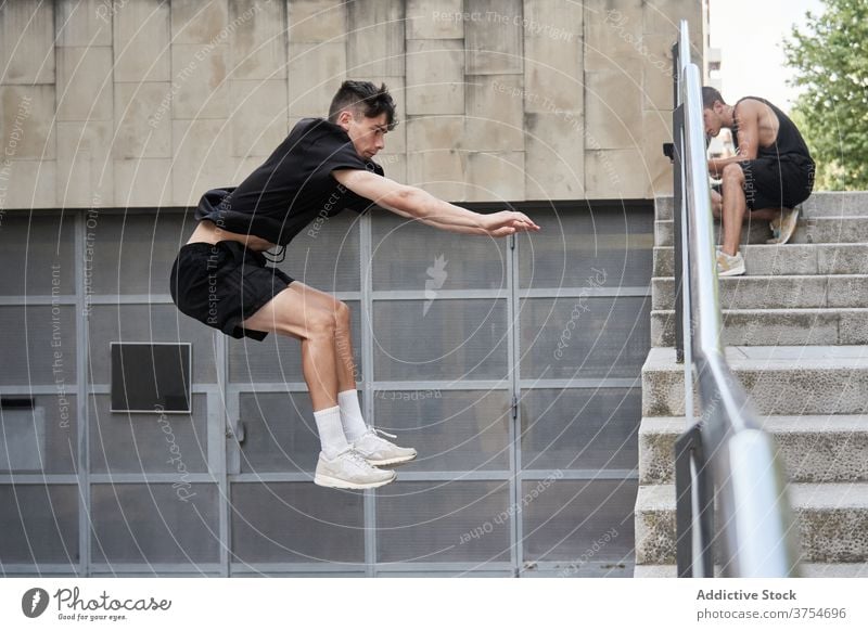 Man doing parkour in city jump stunt man stair trick urban adrenalin extreme male hobby danger courage active activity professional brave energy skill