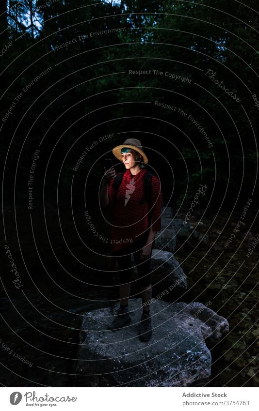 Traveling woman navigating with smartphone in dark forest navigate traveler night map digital navigator using female route woods rock tourist search journey