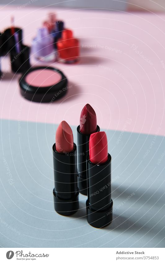 Collection of lipsticks on table in studio makeup collection red color product cosmetic assorted various luxury visage bright set style fashion nail polish