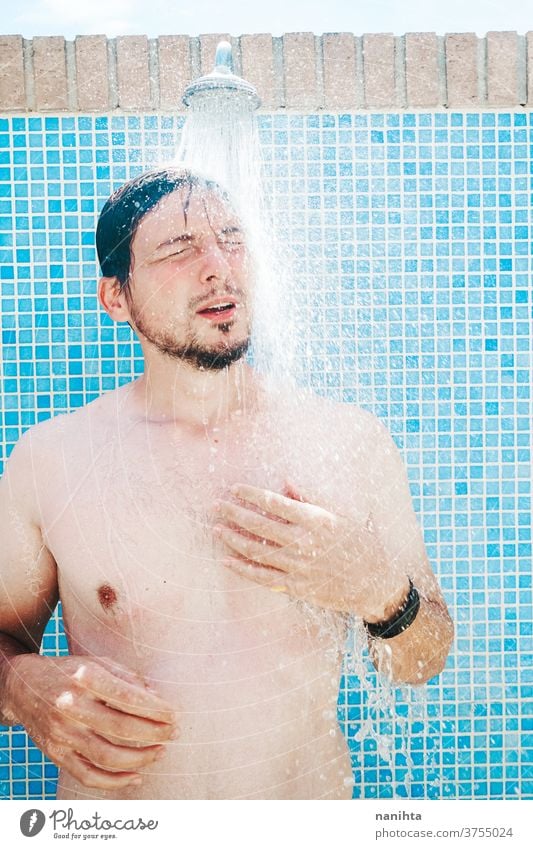 Young man having a shower before pool summer attractive white caucasian tan real real people real man candid fresh freshness cool coolness body real body