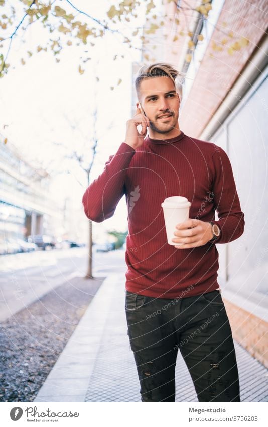 Man talking on the phone outdoors. mobile person adult man male cafe young people coffee handsome happy cell attractive call technology casual lifestyle urban