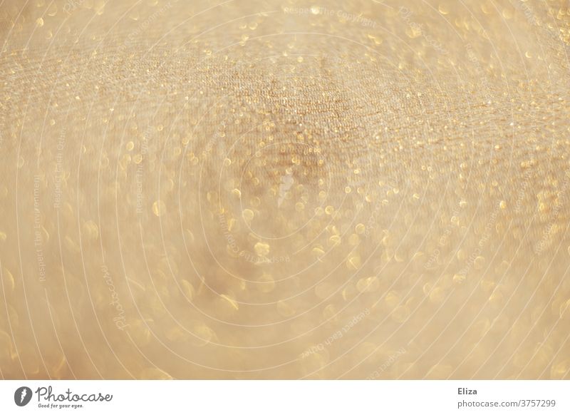Creamy golden glittering fabric background Cloth sparkle cream Close-up Delicate Shallow depth of field structure Bright already light points Detail