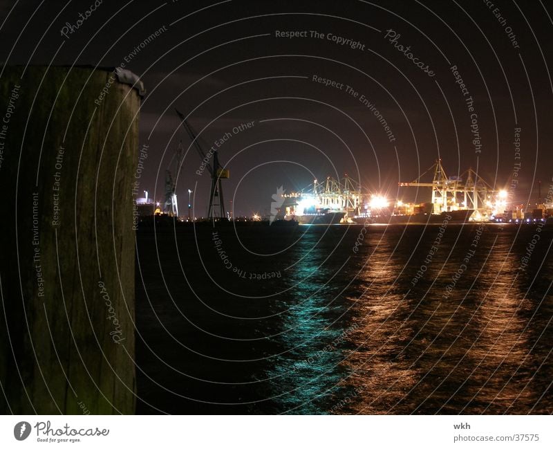 At night in the port of Hamburg Crane Watercraft Night Navigation Harbour Elbe