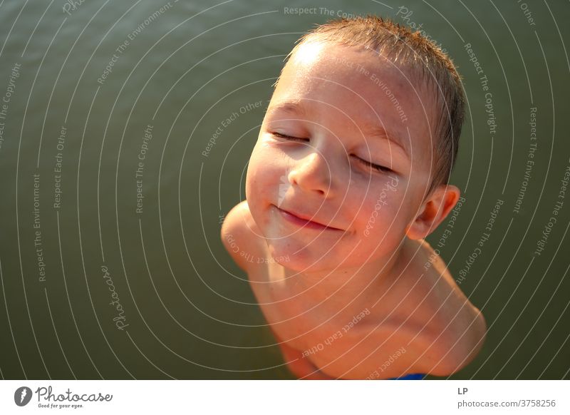 beautiful boy, facing the sun , eyes closed Closed eyes Front view Upper body Portrait photograph Sunbeam Contrast Shadow Light Structures and shapes Pattern