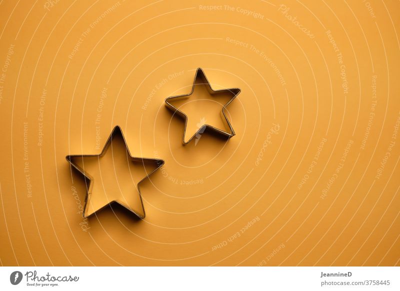 two star shapes on orange background Stars Decoration Feasts & Celebrations Christmas & Advent Orange Colour photo Still Life Tradition Minimalistic Abstract