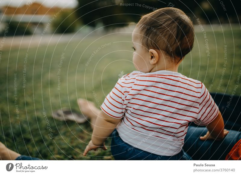Toddler sitting on the grass looking away Child Grass Spring Spring fever Summer Summer vacation Happiness Day Human being Infancy Colour photo Meadow Flower