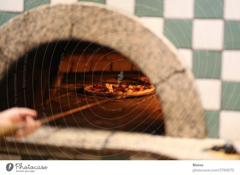 Italian pizza is cooked in a wood-fired oven brick cheese bread cooking dinner flame food hot italian meal mozzarella natural pepperoni restaurant snack tomato