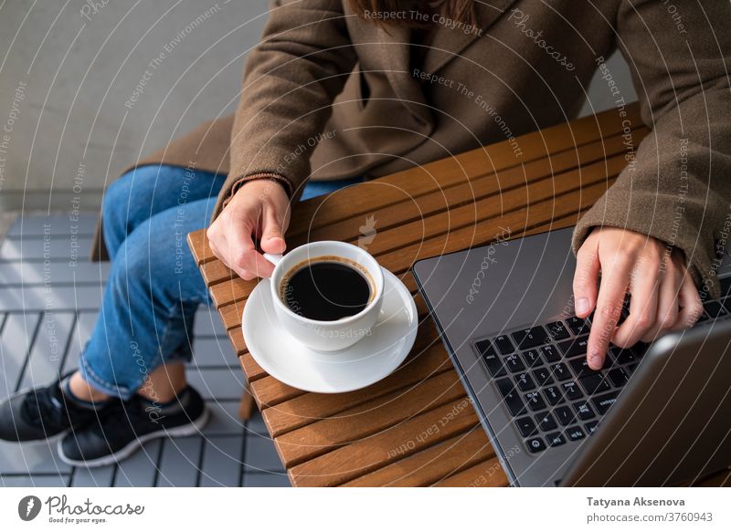 Woman working in street cafe with laptop computer coffee internet person technology female business table modern woman cup lifestyle sitting using people women