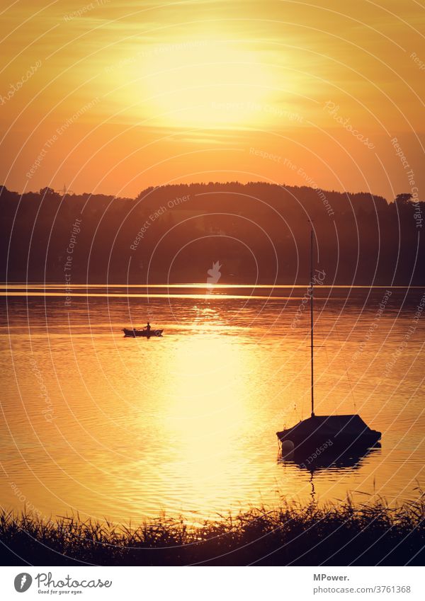 relaxation by the lake Lake Angler boat Sunset Sunlight Evening sun Sailboat Lakeside Body of water Rowboat Vacation mood Summer tranquillity on one's own