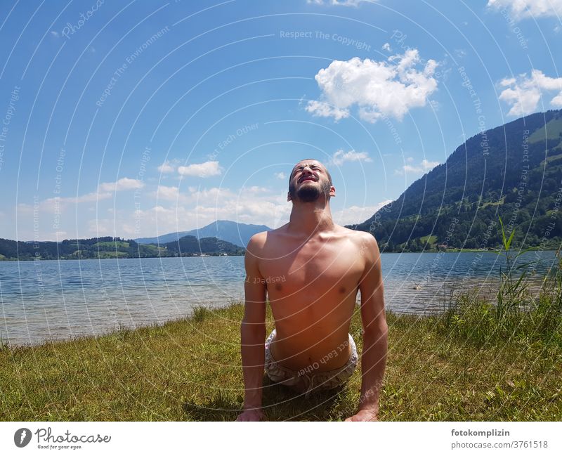 young man doing body gymnastics at a lake stretching exercise Yoga Healthy Man Young man Upper body Fitness Sports Masculine Sports Training Sportsperson Lake