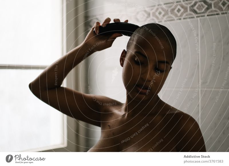 Black woman trimming hair at home cut trimmer bathroom lingerie hairstyle bald appearance female ethnic black african american underwear concentrate care