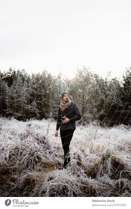 Male photographer in frozen field in winter man snow frost photo camera meadow season male scottish highlands nature grass cold vacation white weather scenic