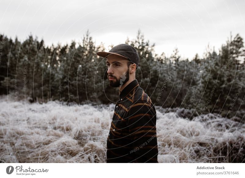 Male standing in frozen field in winter man snow frost meadow season male scottish highlands nature grass cold vacation white weather scenic hat freedom scenery