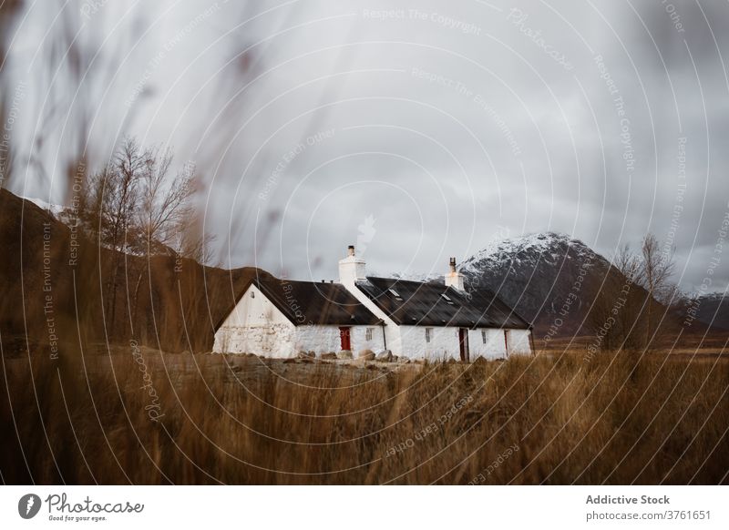 Lonely house in mountainous valley in autumn highland season lonely cold residential scottish highlands scotland uk united kingdom range cottage calm gray sky