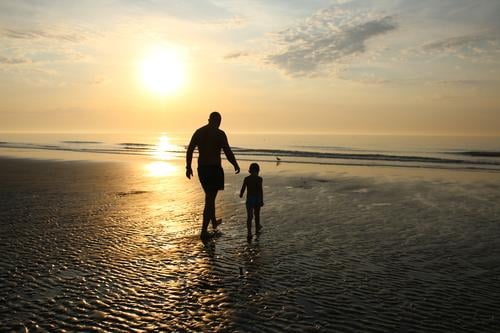 father and sun walking on a beach at sunset Parents Sunbeam Sunlight Structures and shapes Pattern Protection Joie de vivre (Vitality) Happiness Moody Emotions