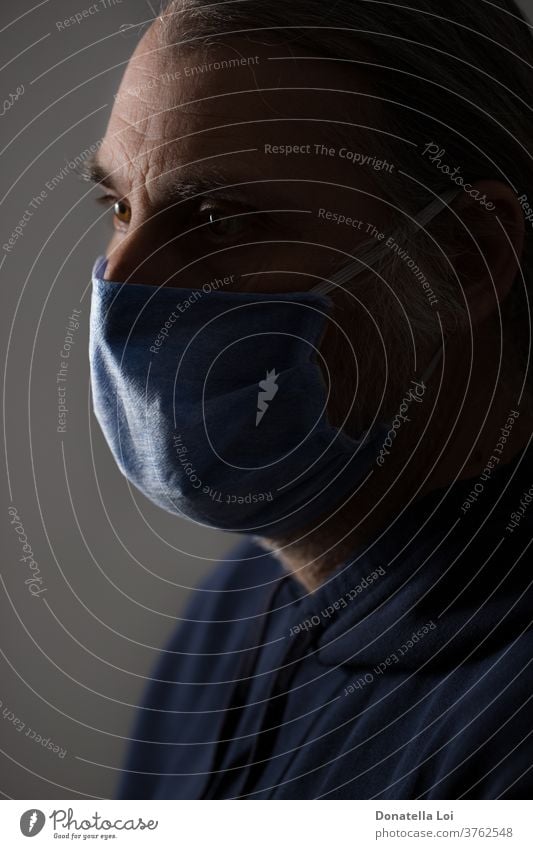 Portrait of Middle-aged man with protective mask bacteria close up common cold concept contagious coronavirus covid-19 disease epidemic face fever flu hand head