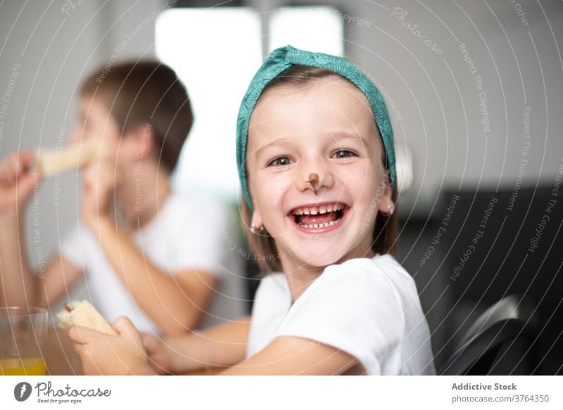 Siblings eating chocolate bread girl boy excited child amazed children cheerful food preteen optimistic positive breakfast mouth fun female sweet happy young