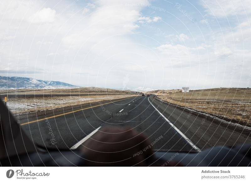 Car riding on road among desert winter valley car drive mountain windshield route roadway travel highway asphalt usa united states america journey trip